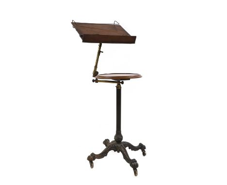 A Victorian mahogany and cast iron telescopic music stand,manufactured by John Carter, the mahogany top raised on a brass, jo