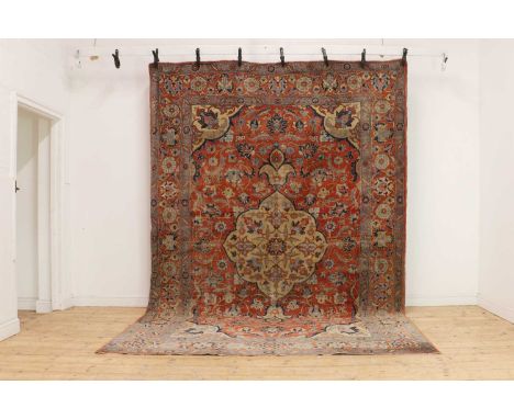 A Heriz wool carpet, first half 20th century, with a large central medallion to a red field, 355 x 247cmCondition ReportHeavi