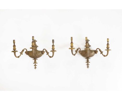 A pair of gilt-metal wall lights,late 19th/early 20th century, French, each of urn form issuing three branches, with ram mask