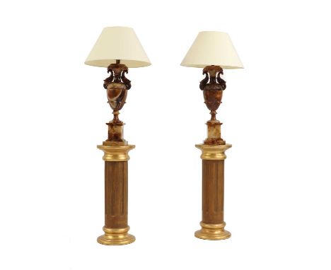 A pair of onyx table lamps,20th century, in the Neoclassical taste, each raised on a painted plaster fluted column, complete 