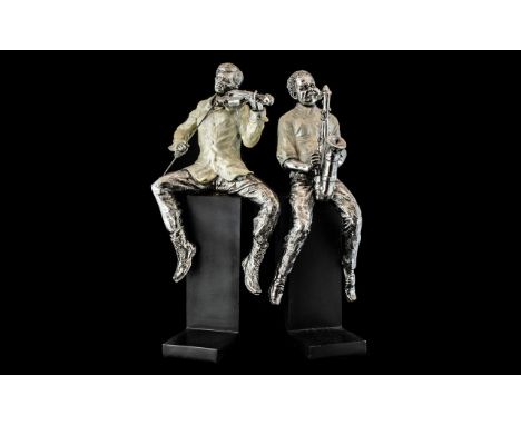 Pair of Jazz Player Book Ends, raised on black base, depicting two men, one playing a violin and one a saxophone. Measure 16"