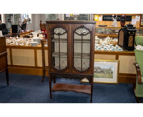 Victorian Mahogany Cabinet with two beaded glass doors, three inner shelves, with lower shelf.  Raised on column legs, decora