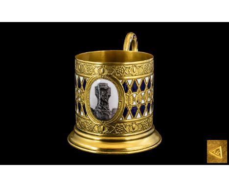Russian Antique Gilt Metal Glass Tea Cup Holder, finely decorated in raised blue and white enamels, with an embossed border a