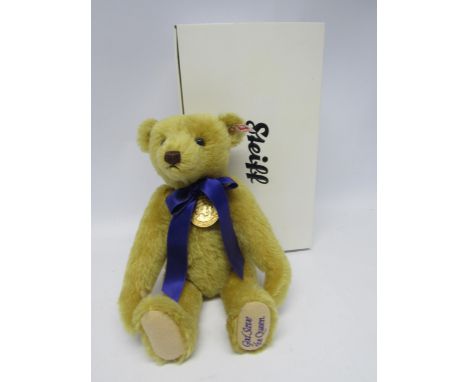 A boxed Steiff 663345 'God Save The Queen' articulated  mohair musical teddy bear with medallion and purple bow, button and w