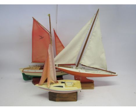 A painted wooden model pond yacht together with two other with plastic hulls including Seifert "Krabbe" (3, longest 58cm) 
