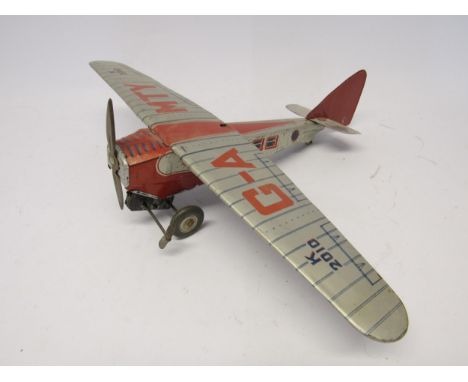 A Mettoy clockwork tinplate K 2010 aeroplane with fixed key, 31cm long, 42.5 cm wingspan 