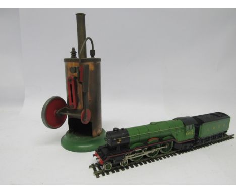 A Burnac Product vertical steam engine, the vertical copper boiler powering a flywheel and single cylinder, on cast metal bas