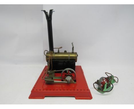 A Mamod live steam stationary engine, the brass horizontal boiler driving a flywheel and twin cylinder, together with an addi
