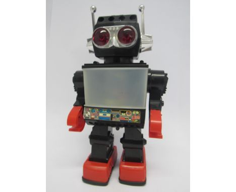 A 1980's plastic battery operated robot, finished in black, red and chrome, 32cm tall 