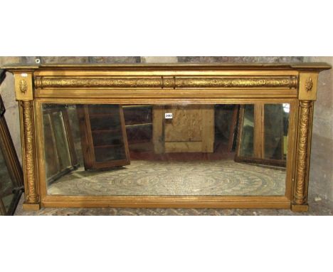 A 19th century gilt framed chimney glass mirror of rectangular form with reeded slip and split column surround with foliate d
