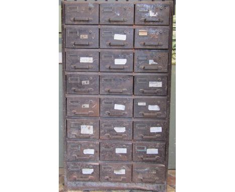 A pair of vintage industrial steel floorstanding office cabinets, each enclosing an arrangement of twenty four index filing d