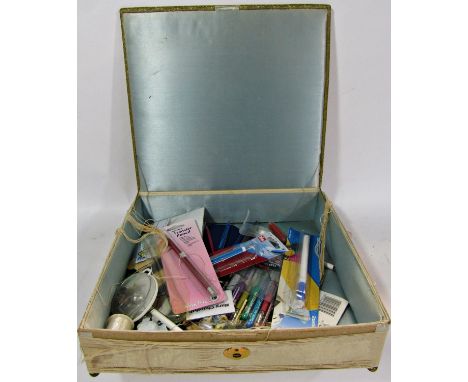 A vintage box of intricately embroidered silk floral lid raised on brass ball feet, ((af) 