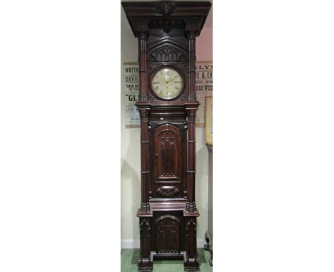 A most unusual Victorian gothic longcase clock, the case supported by four columns, the trunk with lancet panelled door and l