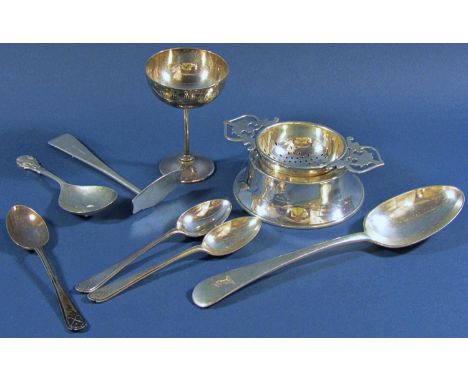 A mixed selection of silver consisting of three teaspoons with gold clubs, a tea strainer on a later stand, a single dessert 