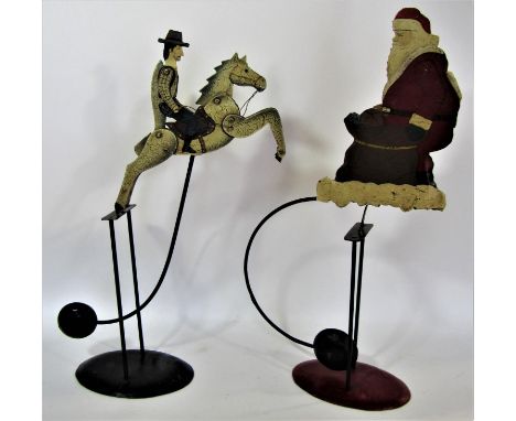 A balance toy vintage Father Christmas and a vintage balance toy of a cowboy riding a bucking horse 