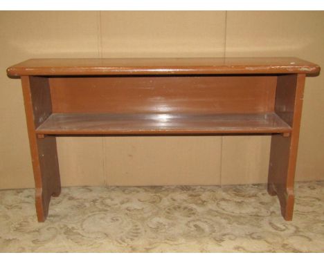 A vintage painted pine bench incorporating an open bookshelf 115cm w x 28cm d x 63cm h 