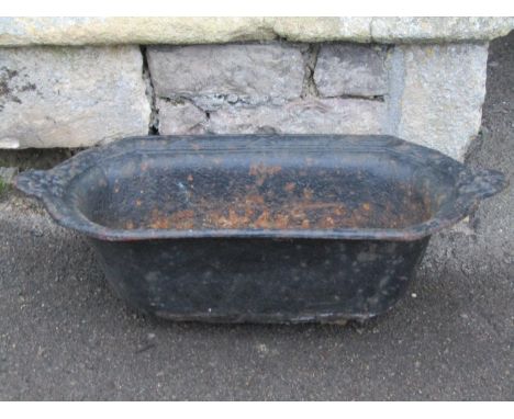A vintage cast iron planter of lozenge form with raised relief rim, 63 cm long x 32 cm wide (af) 
