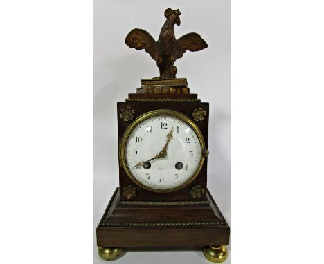 A 19th century French mantel clock, the timber case with applied brass mounts surmounted by a cockerel upon two books with en