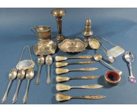 An assortment of english hallmarked silver to include a pepper pot, ashtray, sherry ladle, assorted teaspoons, a small dish, 