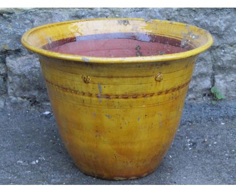 A vintage ochre glazed terracotta planter/pan of circular tapered form with flared rim, 42 cm diameter x 31 cm high 