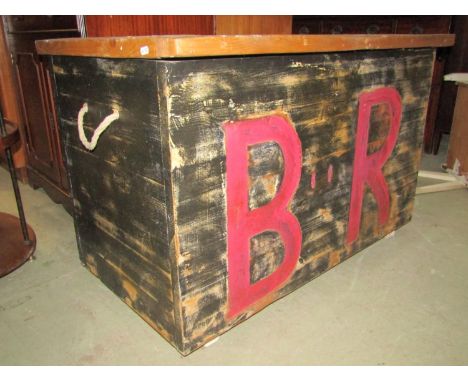 A substantial reclaimed pine box with hinged lid, partially painted finish and initialled B R, 105 cm wide x 64 cm deep x 68 