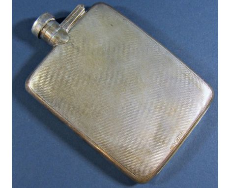 A silver Engine turned flat hip flask with a screw top lever stopper, 9cm long, to hold 5/16ths of a pint, Birmingham 1926, m