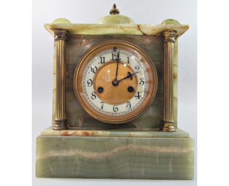 A late 19th century onyx mantel clock of classical form with brass supports enclosing an eight day striking movement 