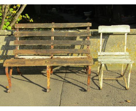 A weathered two seat garden bench with timber lathes and sprung steel supports, together with an accompanying chair (af) for 