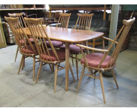 An Ercol light elm and beechwood dining table of rectangular form with moulded outline raised on square tapered and splayed s