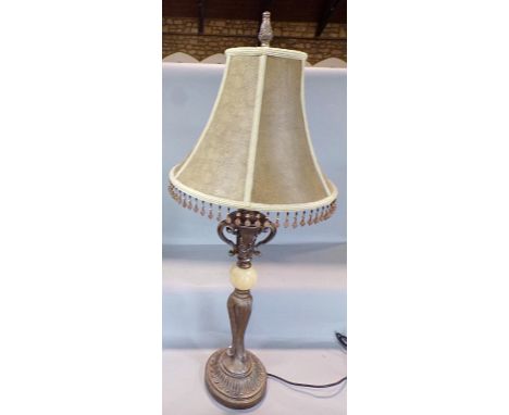 A Neo Classical style table lamp with a silk effect shade with beaded drops on a silver finished base. 85cm high approx 