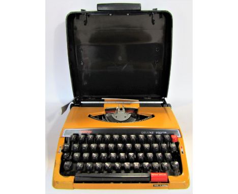 A brother Deluxe 250TR vintage typewriter in an orange colourway 