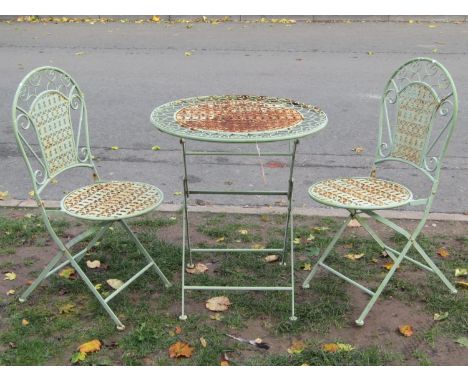 A three piece light green painted folding steel garden terrace set with decorative pierced detail, table 68 cm diameter 