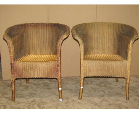 A pair of vintage Lloyd Loom chairs with swept arms in gold colourway together with one other similar (3) 