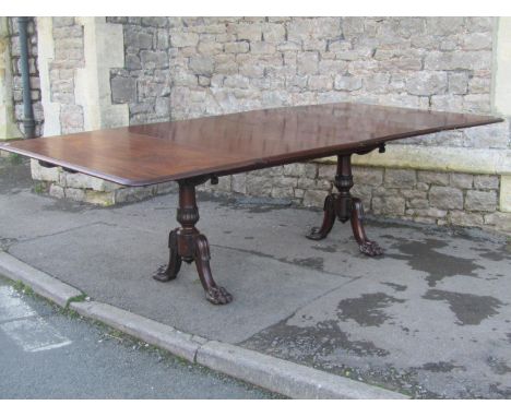 An unusual Regency mahogany patent dining table by Wilkinson &amp; Son number 5579 (stamped to frame) raised on a pair of cur