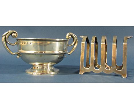 A silver late Victorian double handled trophy with scrolled handles, Birmingham 1898, maker J W and a silver toast rack, 7.4o