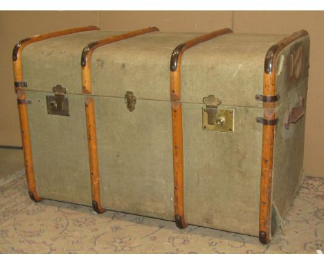 A vintage fibre and timber lathe bound cabin trunk with brass fittings and stitched leather strap handles, 81 cm long x 51 wi