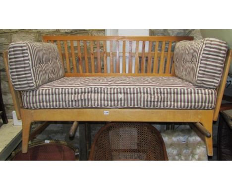 A mid 20th century sofa bed with beechwood and pine framework, Heals spring centre mattress and side cushions, 146 cm wide 