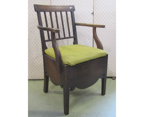 A Georgian mahogany commode chair with reeded stick back and open arms (af) 