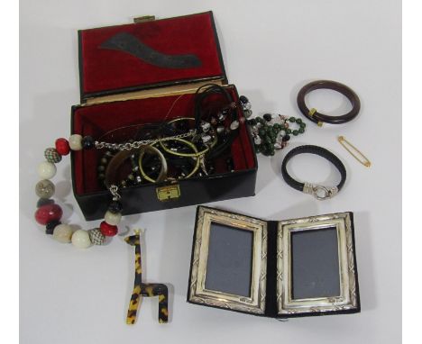 Collection of costume jewellery to include a plaited leather bracelet with silver clasp, a wooden crossover bangle, etc, also