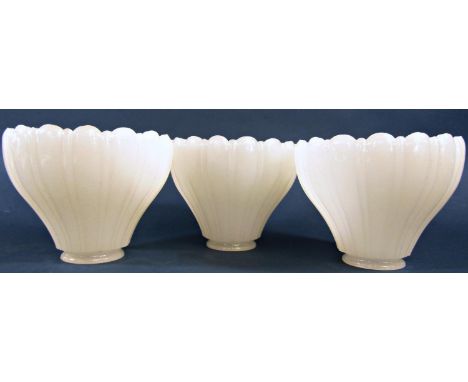 Three Vaseline moulded glass light shades with scalloped edge 12cm high x 14.5cm diam. 