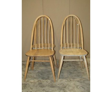 A set of four stripped Ercol Quaker elm and beechwood high hoop and stick back dining chairs