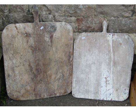Two vintage rustic outsized pine breadboards, the largest example 54 cm x 75 cm (including handle) 