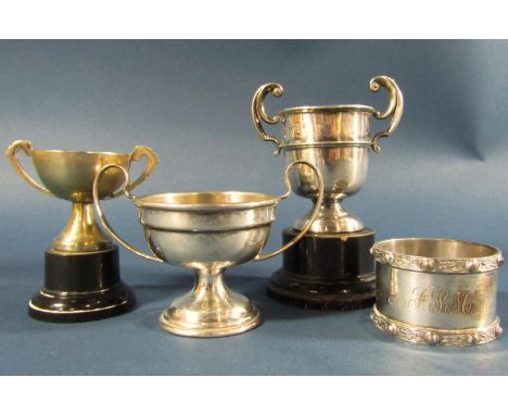 Three small silver trophies with a single napkin ring, 4.6oz including one trophy base 