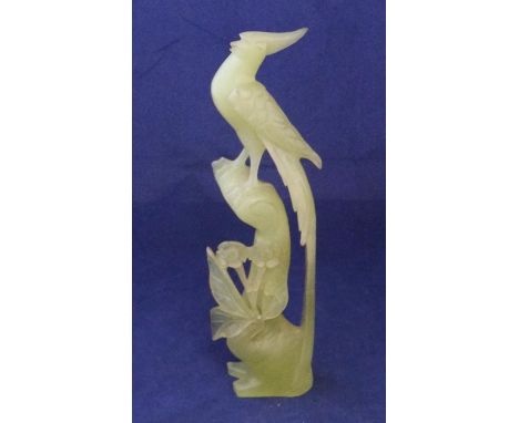 Finely carved jade statue of a bird amongst foliage26cm high  Good overall condition without any particular problems