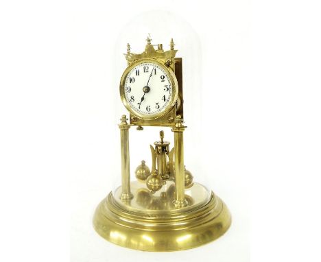 Brass torsion clock, the 2.75" dial upon pillar supports and a stepped circular base, under a glass dome, 12" high overall