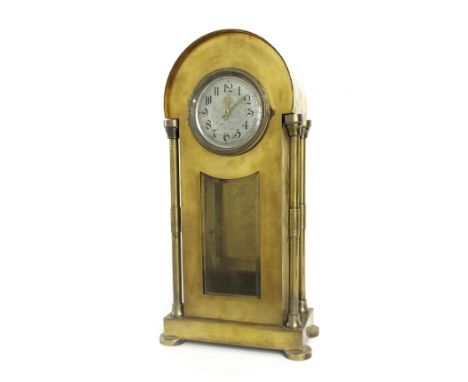 Unusual tall brass torsion mantel clock, the 4.25" silvered dial over a bevelled glazed pendulum window and within a pillared