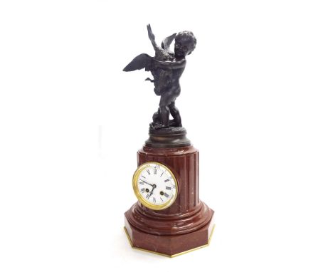 French bronze and red marble two train figural pillar clock, the movement striking on a bell, the 3.75" white dial inset into