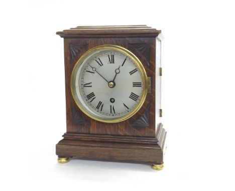 Oak single fusee mantel clock, the 5.25" silvered dial within a stepped case with carved spandrels, 10.75" high (pendulum and