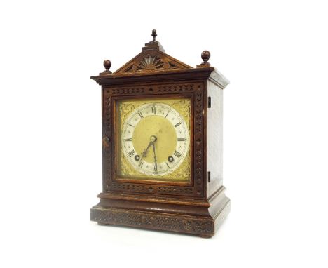 German oak two train mantel clock, the W & H movement striking on a gong, the 5" square brass dial within a shallow carved st