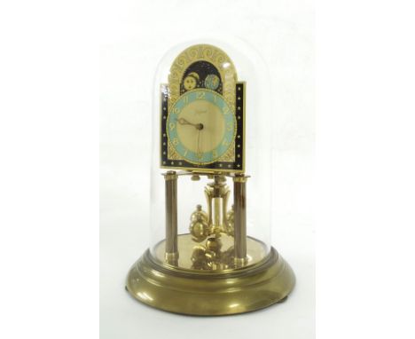 Wurthner brass torsion mantel clock, the 4" coloured arched dial with moon phase, supported upon two cylindrical columns, ste